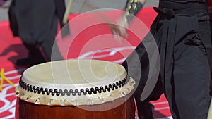 Japanese artist playing on traditional taiko drums