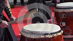 Japanese artist playing on traditional taiko drums