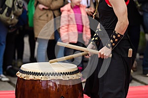 Japanese artist playing on traditional taiko drums