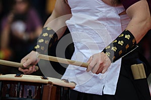 Japanese artist playing on traditional taiko drums