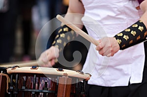 Japanese artist playing on traditional taiko drums