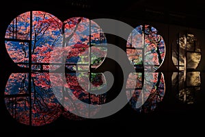 Japanese autumn scenery in round windows with reflection