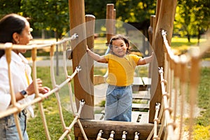 Japanese Baby Girl With Mommy On Playground Walking Swinging Bridge