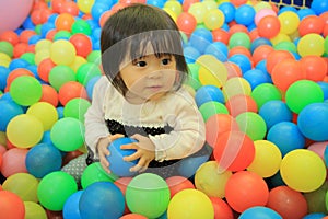 Japanese baby girl playing in ball pool