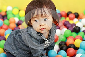 Japanese baby girl playing in ball pool