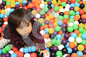 Japanese baby girl playing in ball pool