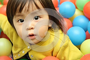 Japanese baby girl playing in ball pool