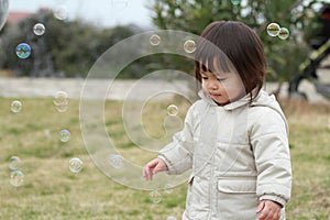 Japanese baby girl playing with bubble