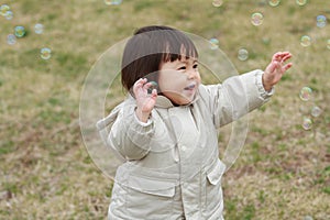 Japanese baby girl playing with bubble