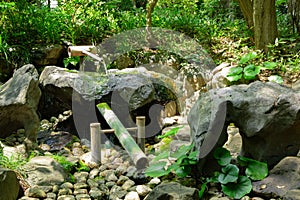 A Japanese Bamboo Water Fountain Shishi-Odoshi in Zen Garden
