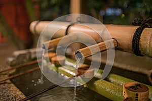 Japanese Basin, a tsukubai with bamboo ladles in the entrance of Yasaka Shrine in Kyoto, Japan