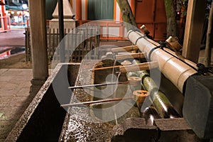 Japanese Basin, a tsukubai with bamboo ladles in the entrance of Yasaka Shrine in Kyoto, Japan