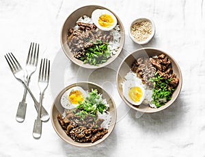 Japanese beef, rice and boiled egg bowl on light background, top view. Asian style food concept