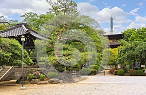 Japanese bell tower and buddhist three-story timber pagoda in gotokuji zen temple.