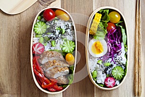 Japanese bento box with chicken, vegetables and rice