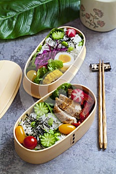 Japanese bento box with chicken, vegetables and rice