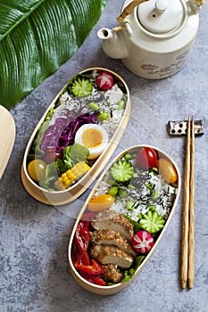 Japanese bento box with chicken, vegetables and rice