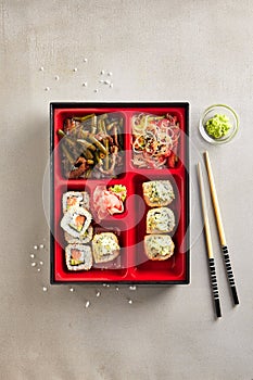 Japanese Bento Box with Sushi Rolls, Salad and Main Course Top V