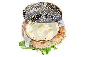 Japanese Black Burger with scrambled eggs and arugula. Cheeseburger with black bun. Isolated on white background. Top photo