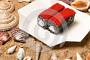 Japanese Black Rice Sushi Roll with salmon, Philadelphia cream cheese and flying fish roe Tobiko caviar on top in delivery box o