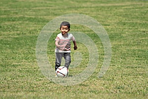 Japanese boy kicking a soccer ball