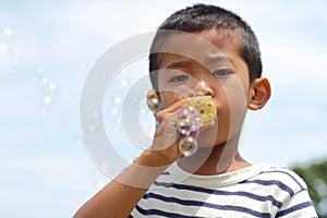 Japanese boy playing with bubble