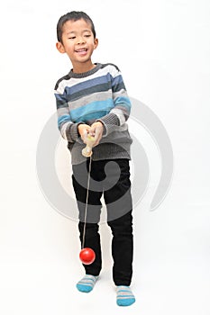 Japanese boy playing cup and ball