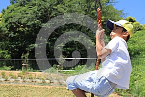 Japanese boy playing with flying fox