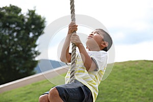 Japanese boy playing with flying fox