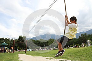 Japanese boy playing with flying fox