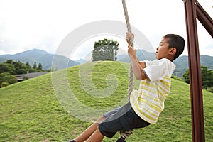 Japanese boy playing with flying fox