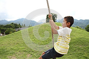 Japanese boy playing with flying fox