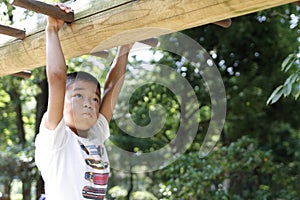 Japanese boy playing with a monkey bars