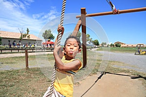 Japanese boy playing with Tarzan rope