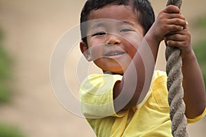 Japanese boy playing with Tarzan rope