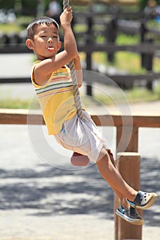 Japanese boy playing with Tarzan rope