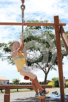 Japanese boy playing with Tarzan rope