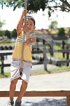 Japanese boy playing with Tarzan rope