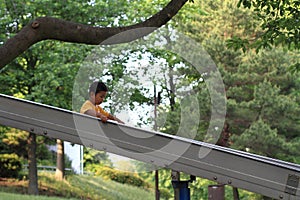 Japanese boy on the slide summer