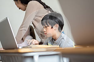 Japanese boy studying on laptop