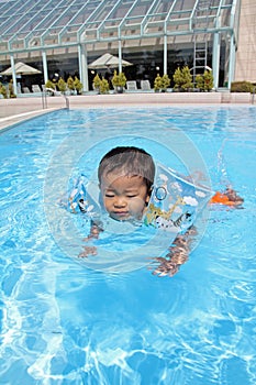 Japanese boy swiming in the pool