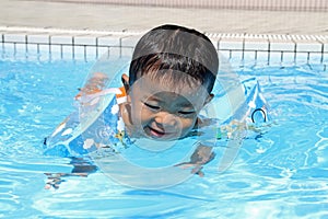 Japanese boy swiming in the pool