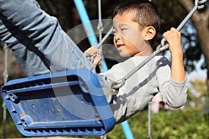 Japanese boy on the swing