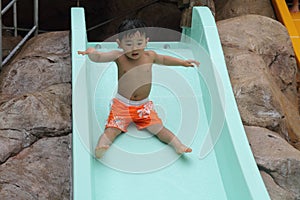 Japanese boy on water slide