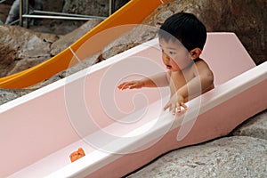 Japanese boy on water slide