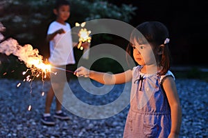 Japanese brother and sister doing handheld fireworks