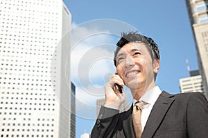 Japanese businessman talks with a mobile phone