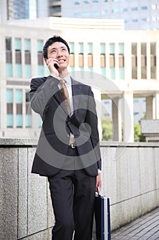 Japanese businessman talks with a mobile phone