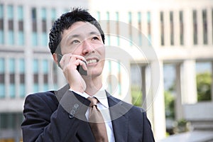 Japanese businessman talks with a mobile phone