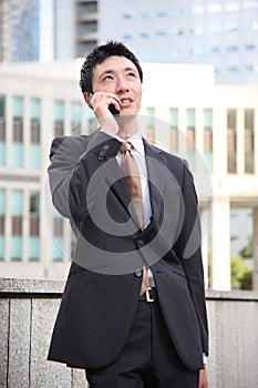 Japanese businessman talks with a mobile phone